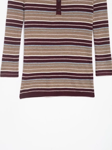 Close-up of the textured rib-knit fabric and buttoned henley collar on a striped cardigan