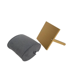Close-up of golden brushed metal L-stand with a grey velvet watch display pillow