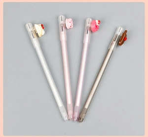 Close-up of four neutral pens with silicone food toppers like cake and donuts