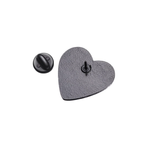 Close-up of the heart enamel pin back with matte texture and black rubber clutch