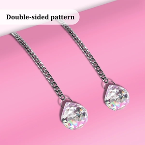 Detail of crystal ball pendants with silver metal chain showing double-sided pattern