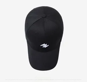 Top down view of black cotton baseball cap with white abstract embroidered logo