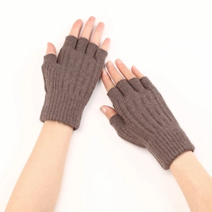 Detailed close-up of brown cable knit texture on cozy fingerless wool arm warmers