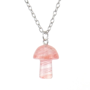 Macro detail of the natural pink quartz mushroom pendant on a polished silver chain