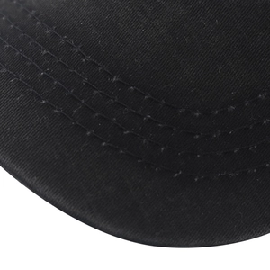Close-up of triple stitching on a black washed cotton baseball cap brim