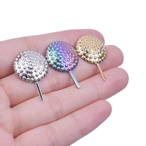 Macro detail of textured 304 stainless steel stud earrings in gold, silver, and rainbow