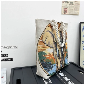 Detail view of ethnic elephant embroidery and cotton rope handles on the canvas tote bag