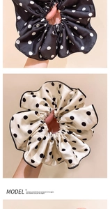 Close-up of elegant polka dot satin scrunchies in black and beige silk texture