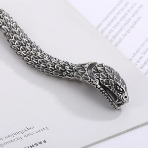 Macro shot of silver snake bracelet with detailed scale textures and punk design