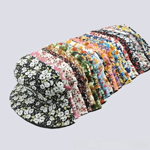 Selection of cotton bucket hats with various floral and sunflower prints in a stacked view