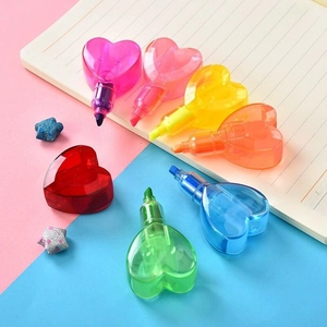 Set of 7 heart-shaped highlighters in multiple colors scattered on a notebook