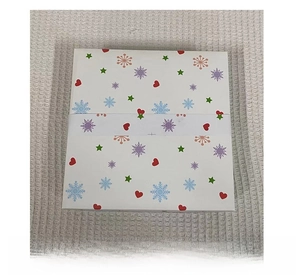 Back view of a Christmas gift box with colorful snowflake and heart patterns
