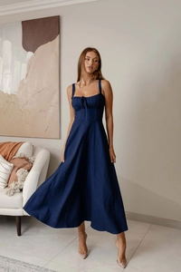 Detail of dark blue denim midi dress with backless design and cinched waistline