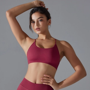 Detail of ribbed hem support and seamless knit on wine red sports bra and leggings