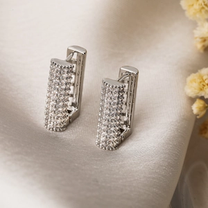 Silver-plated rectangular hoop earrings with pavé zircons on soft silk fabric