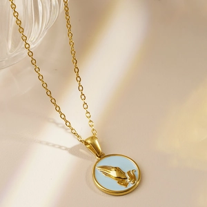Golden stainless steel necklace with blue enamel pendant featuring praying hands relief