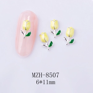 Macro detail of 6x11mm yellow tulip nail art charms with silver edges and green leaves
