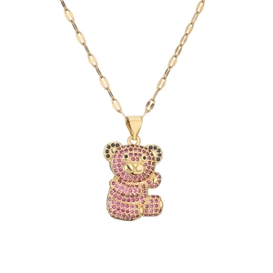 Gold-plated necklace featuring a teddy bear pendant with pink and black crystals on white