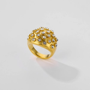 Macro detail of gold dome ring featuring densely paved clear rhinestones and shiny finish