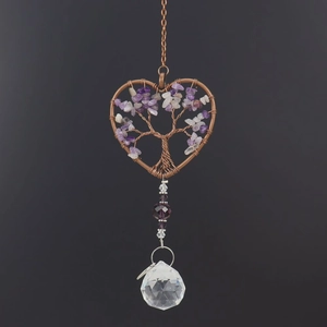Detail of copper wire-wrapped heart life tree with crystals and a clear prism ball