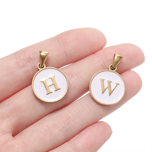 Golden stainless steel round alphabet pendants with white enamel letters H and W