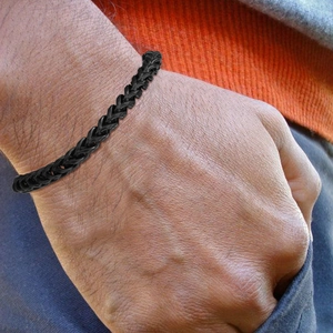 Men's hip hop black keel link bracelet in stainless steel worn on wrist in a casual pose