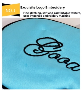 Detail of lake blue satin eye mask showing high-quality black Good embroidery and piping