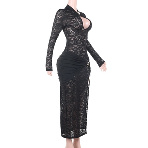 Detail view of black lace dress showing intricate fabric patterns and slit design