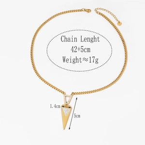 Detail showing the golden layered necklace with arrow pendants and crystal inlay details