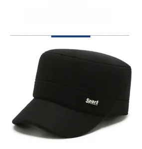 Detail view of black wool blend flat top cap featuring silver Sport metal emblem decoration