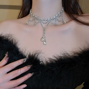 Close-up of sparkling silver choker with layered diamond fringes and teardrop crystals