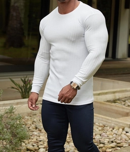 Close-up of white ribbed knit fabric on men's slim fit long sleeve muscle tee