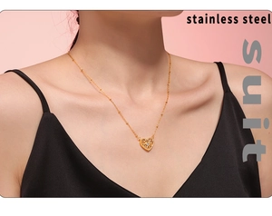 Close-up of a double-layered gold heart pendant necklace in polished stainless steel