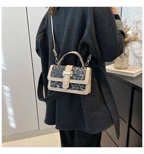 Leopard print crossbody bag shown on model with neutral tones and adjustable strap