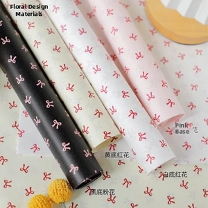 Detail of matte floral gift wrapping paper with various colorful bow patterns