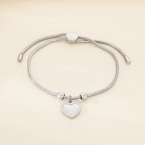Detail of silver heart charm on adjustable snake bone chain with polished metal finish