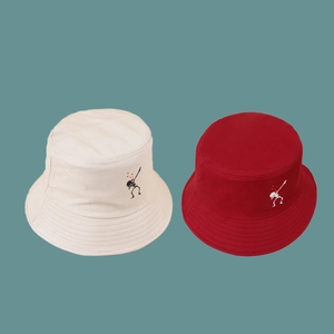 Fashionable bucket hats with embroidered skeleton dab design in beige and burgundy colors