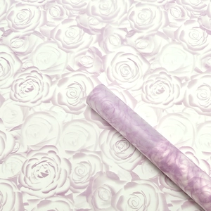 Detail of purple floral bouquet wrapping paper with elegant rose pattern and matte texture