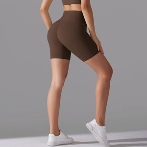 Detail of high-waist seamless brown yoga shorts with butt-lifting stitching effect