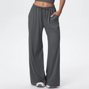 Close-up of charcoal gray wide-leg trousers featuring an elastic drawstring waistband and side pockets