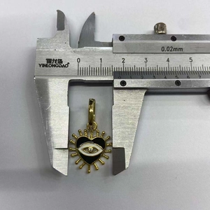 Macro shot of evil eye heart pendant being measured with a caliper for 2.3cm width