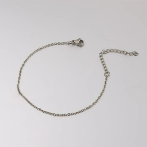 Detailed macro view of 1.5mm stainless steel cross chain with lobster clasp and extender
