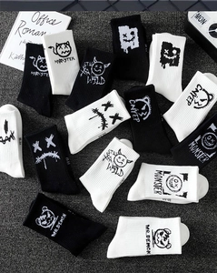 Detail of knit crew socks with monster patterns and street style letter prints