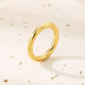 Macro shot of 18k gold plated stainless steel ring on a textured stone surface