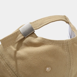 Detail of adjustable metal buckle and stitching on khaki cotton baseball cap back