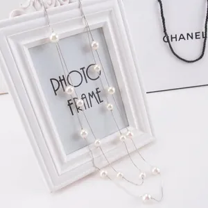 Elegant multi-layer long pearl necklace with white round beads and silver chain