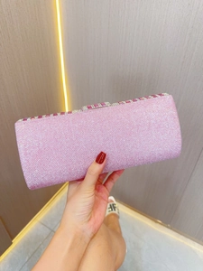 Close-up of elegant pink rhinestone evening clutch bag with sparkling sequins and metal clasp