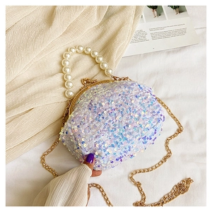 Detail of pearlescent sequin mini shell bag with pearl handle and golden chain
