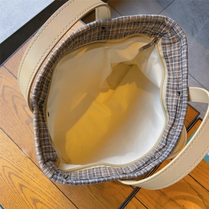Detailed top view of vintage plaid tote bag showing inner lining and secure metal zipper