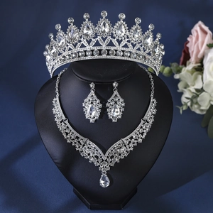 Macro shot of sparkling silver bridal tiara, necklace and earring set with drop stones